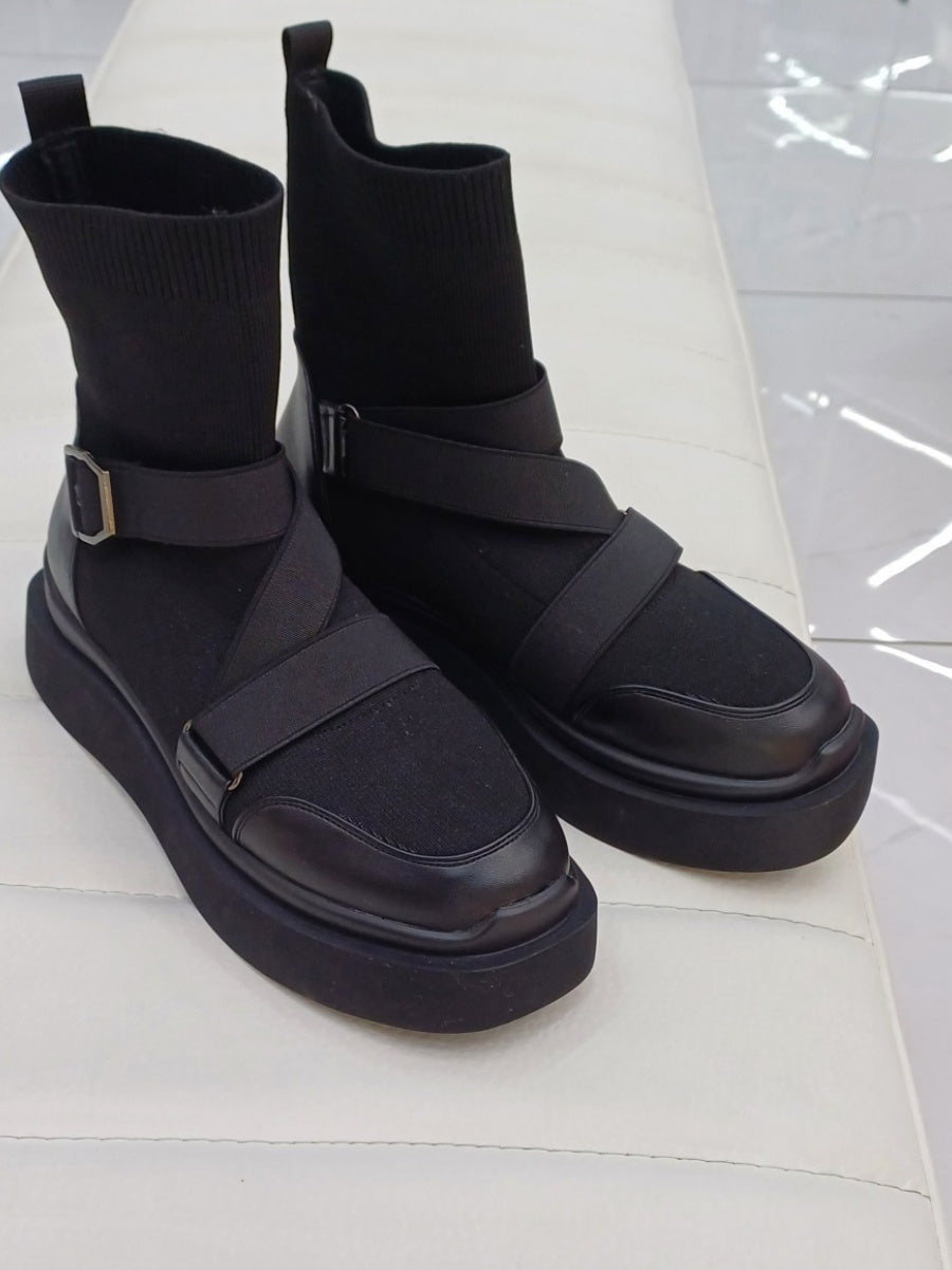 Black high heeled arched boots