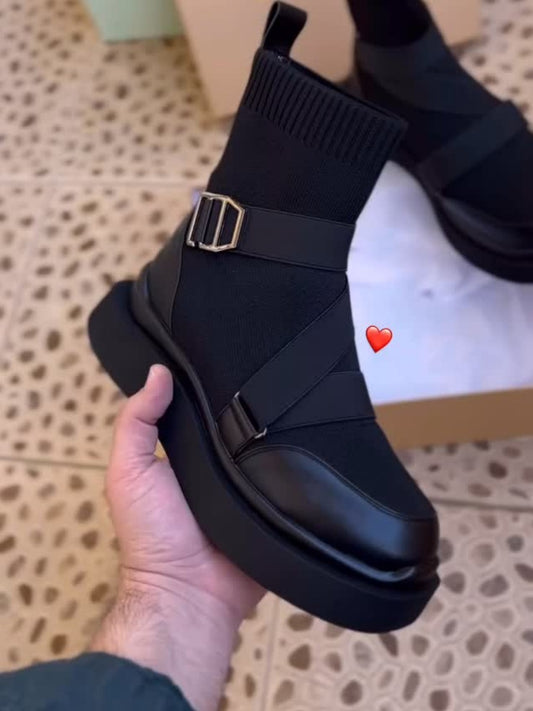 Black high heeled arched boots