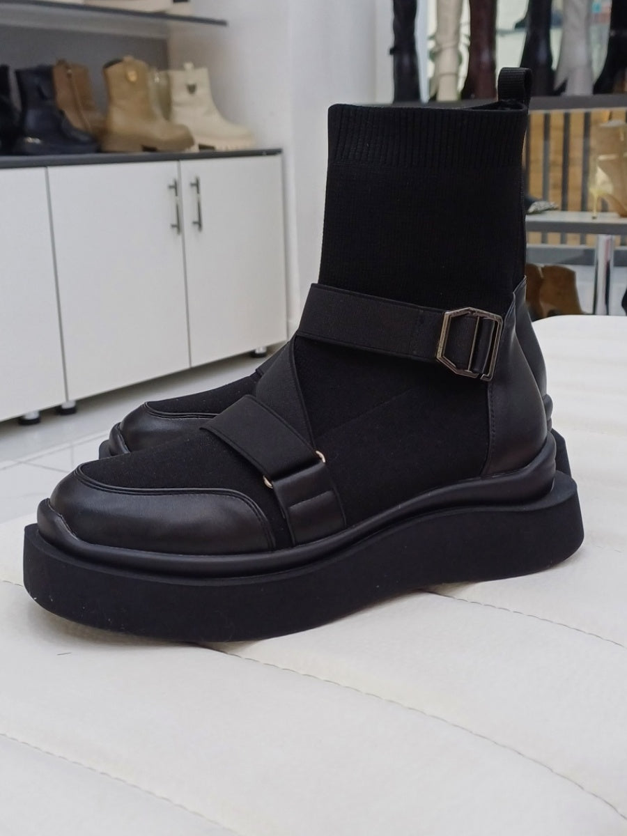 Black high heeled arched boots