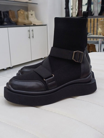 Black high heeled arched boots