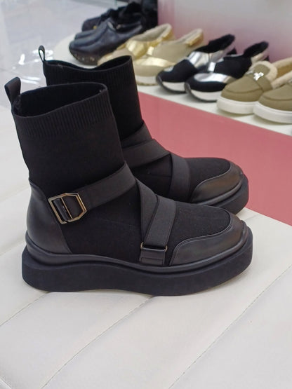 Black high heeled arched boots