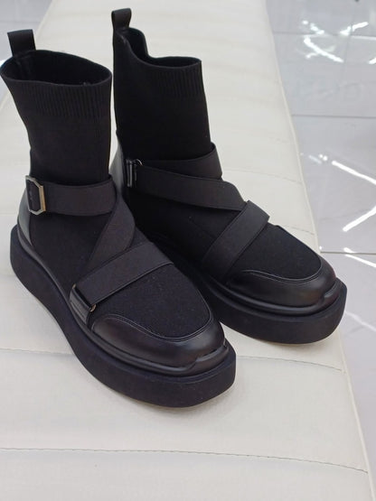 Black high heeled arched boots